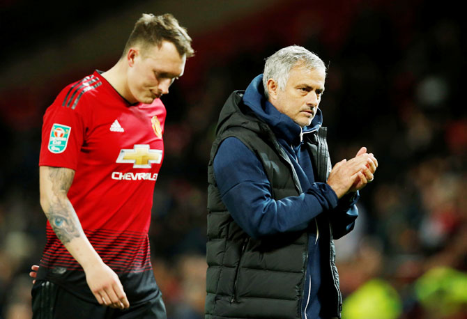 Manchester United's Phil Jones and manager Jose Mourinho wear a dejected look after the match 