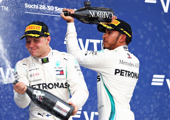 Race winner Lewis Hamilton of Mercedes GP and second placed Valtteri Bottas of Mercedes GP celebrate on the podium during the Russian Formula One Grand Prix at Sochi Autodrom in Sochi, Russia, on Sunday