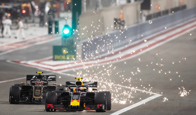  Sparks fly behind France's Pierre Gasly driving the (10) Aston Martin Red Bull Racing RB15 ahead of Denmark's Kevin Magnussen driving the (20) Haas F1 Team VF-19 Ferrari on track