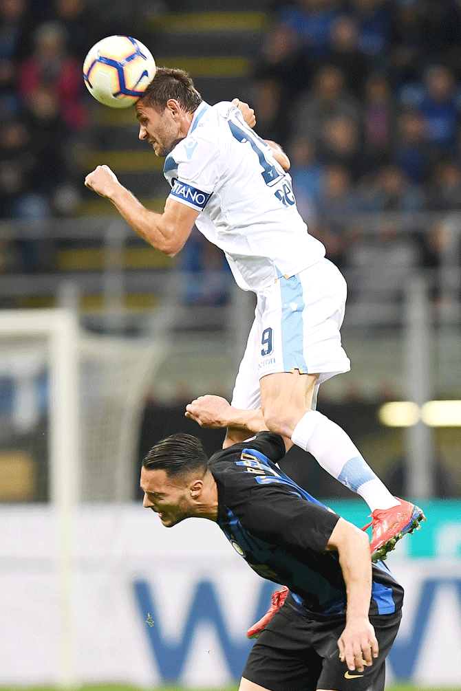 Lazio's Senad Lulic and Inter Milan's Danilo D'Ambrosio in an aerial challenge during their Serie A match at San Siro in Milan on Sunday