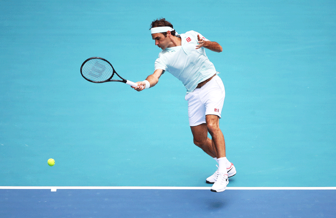 Switzerland's Roger Federer in action against USA's John Isner during the Miami Open final on Sunday