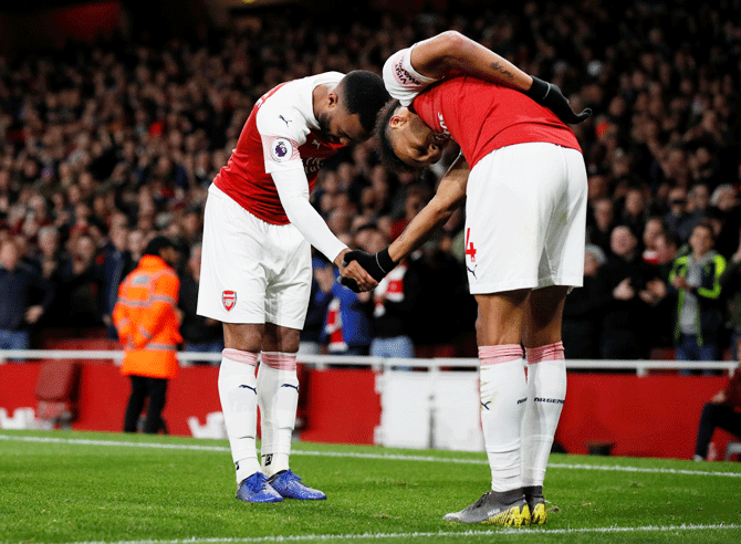 Arsenal's Alexandre Lacazette celebrates with Pierre-Emerick Aubameyang on scoring their second goal against Newcastle