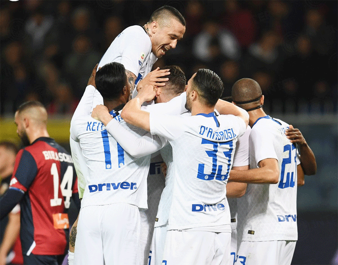 Inter Milan's players celebrate a goal by Mauro Icardi in their Serie A match against 10-man Genoa