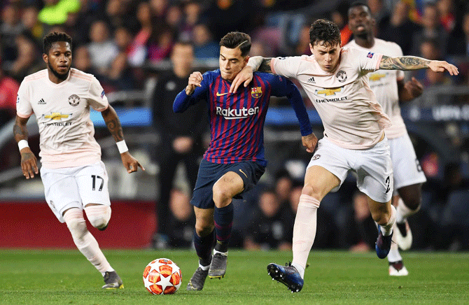Barcelona's Philippe Coutinho is challenged by Manchester United's Victor Lindelof