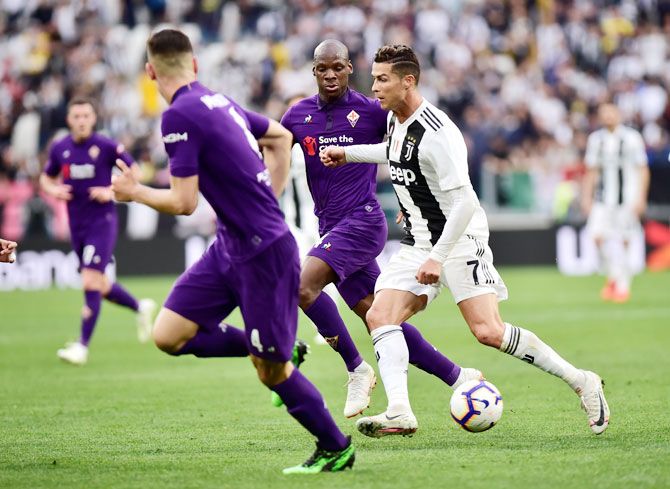 Juventus' Cristiano Ronaldo is challenged by Fiorentina's Bryan Dabo during their match Serie A match at Allianz Stadium in Turin on Saturday