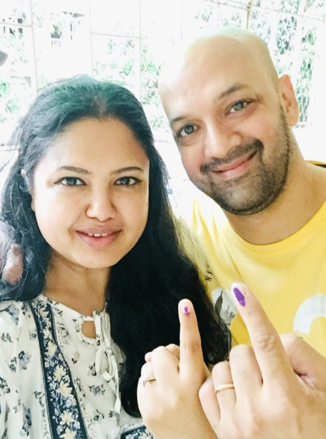 Former India hockey captain Viren Rasquinha and his wife after polling