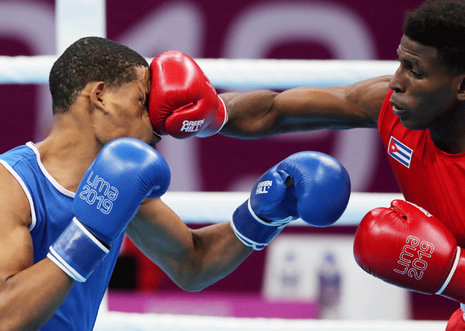 Cuba's Andy Cruz (right) lands a punch on Dominican Republic's Hendri Cedeno Martinez during their men's light welter weight 64kg quarter-final boxing bout on July 29