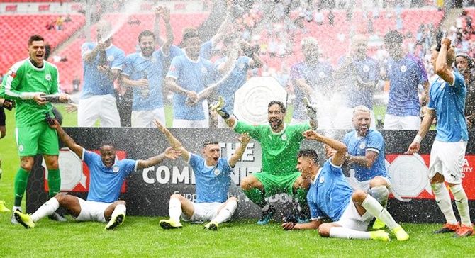 Manchester City players celebrate with the Community Shield