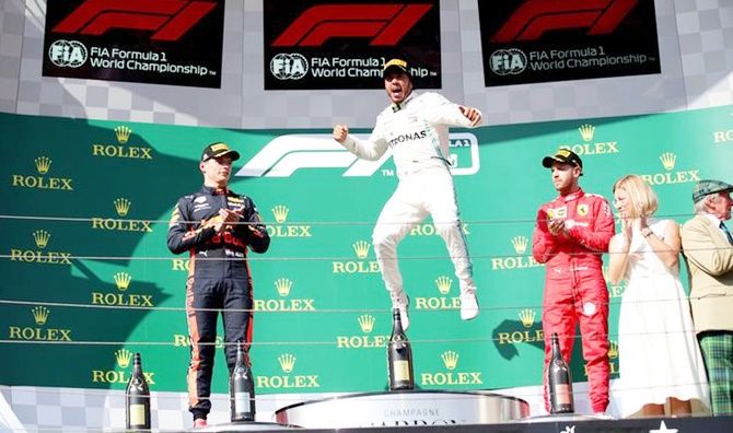Mercedes's Lewis Hamilton, Red Bull's Max Verstappen and Ferrari's Sebastian Vettel celebrate finishing first, second and third respectively in the Hungarian Grand Prix