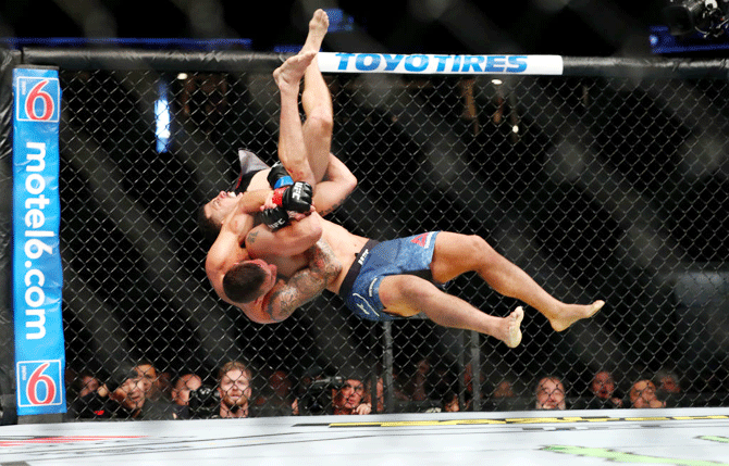 Christos Glagos is slammed onto the ground by Drakkar Klose in the third round during their Lightweight Bout of  UFC 241 at Honda Center in Anaheim, California, on Saturday, August 17