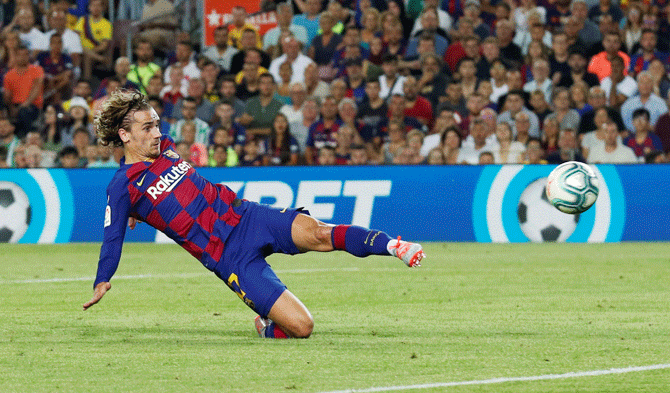 Barcelona's Antoine Griezmann scores their first goal against Real Betis during their La Liga match at Camp Nou in Barcelona on Sunday