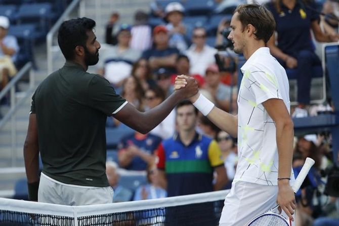 Daniil Medvedev, right, and Prajnesh Gunneswaran meet at the net after their first match in the first round match on Day 1 of the US Open