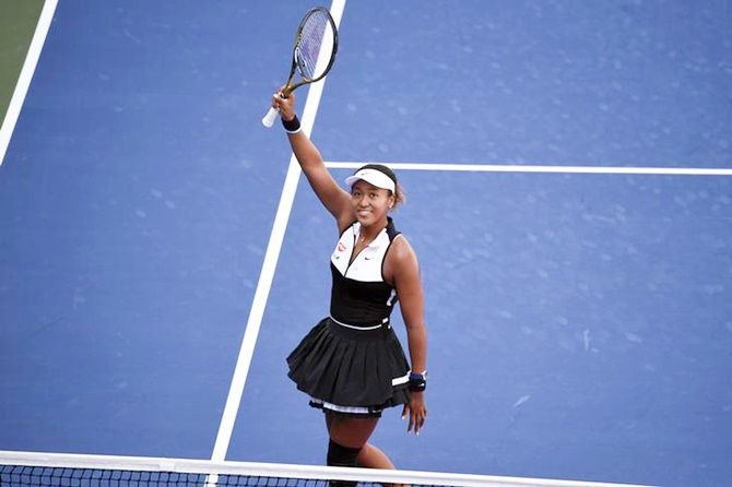 Naomi Osaka waves to the crowd after defeating Magda Linette.