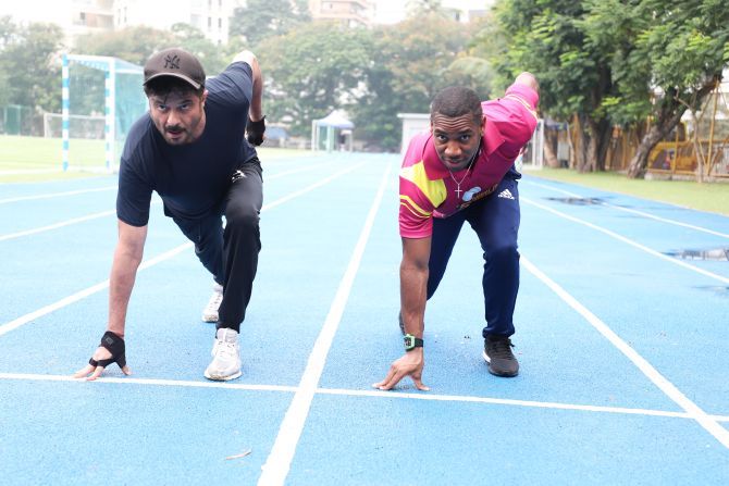 Veteran Bollywood star Anil Kapoor and Olympic silver medallist Yohan Blake warm up before a sprint in Mumbai on Thursday