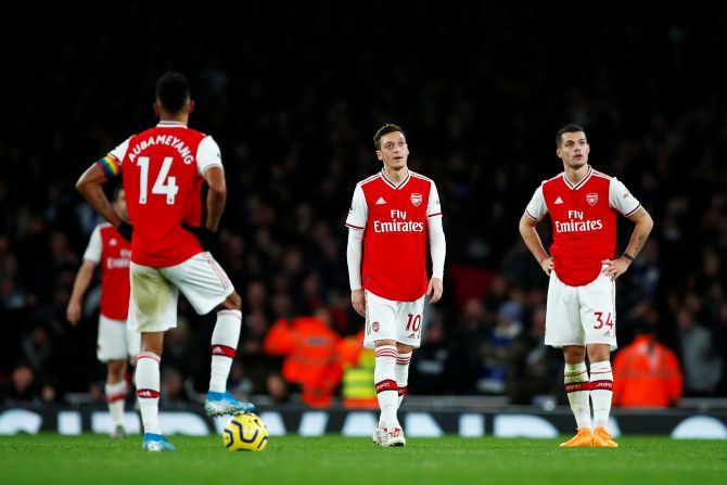Arsenal's Mesut Ozil and Granit Xhaka look dejected after Brighton & Hove Albion's Neal Maupay scored their second goal during their English Premier League match at Emirates Stadium in London on Thursday