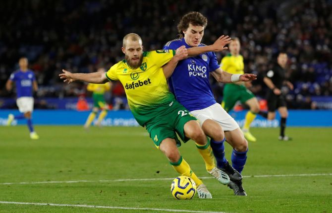 Norwich City's Teemu Pukki vies with Leicester City's Caglar Soyuncu 