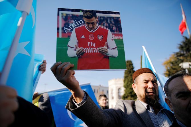 An ethnic Uighur demonstrator holds a placard with a picture of English soccer club Arsenal's midfielder Mesut Ozil during a protest against China in Istanbul, Turkey December 14, 2019