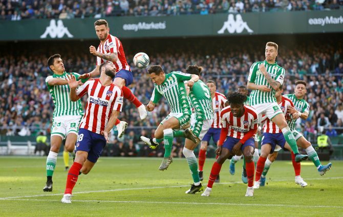 Atletico Madrid's Saul Niguez in action with Real Betis' Aissa Mandi during their La Liga match at Estadio Benito Villamarin in Seville, Spain, on Sunday