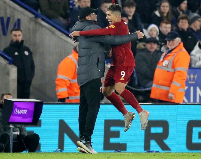 Liverpool's Roberto Firmino celebrates with manager Juergen Klopp on scoring their third goal against Leicester City at King Power Stadium in Leicester