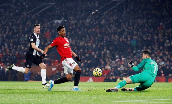 Manchester United's Anthony Martial scores past Newcastle's keeper for their fourth goal at Old Trafford in Manchester 