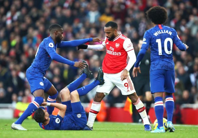 Arsenal's Alexandre Lacazette is restrained by a Chelsea player as he clashes with Chelsea's Jorginho