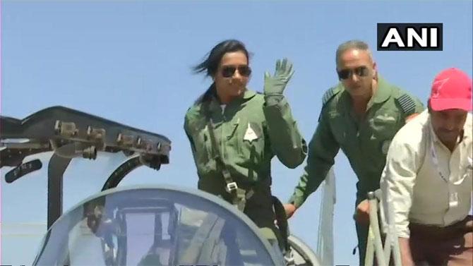 Shuttler PV Sindhu waves as she is about to take off for a sortie in the indigenous Light Combat Aircraft, Tejas, in Bengaluru on Saturday