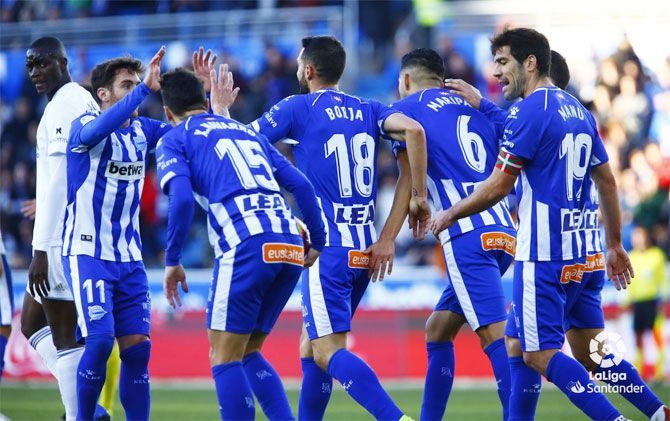 Deportivo Alaves players celebrate after scoring against Valencia on Saturday