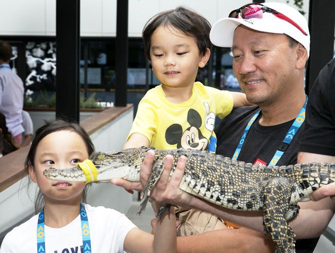 Former player Michael Chang and his children meet a crocodile