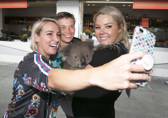 USA's Bethanie Mattek-Sands takes a selfie with her mixed doubles partner Dutchman Demi Schuurs and a koala