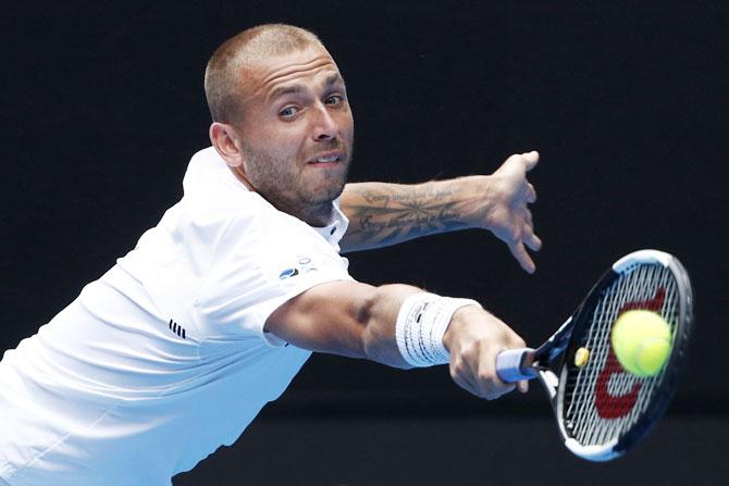 Britain's Dan Evans plays a backhand return during his match against Switzerland's Roger Federer