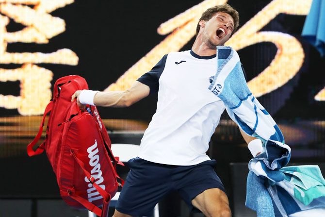 Spain’s Pablo Carreno Bust throws his bag in frustration after losing his fourth round match against Japan’s Kei Nishikori on Monday, January 21