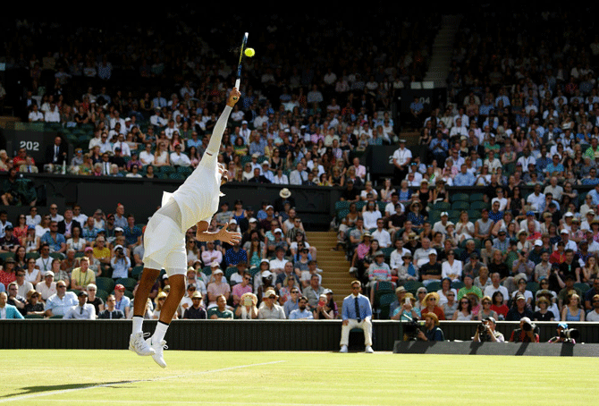 Australia's Nick Kyrgios serves during his 2nd round match against Rafael Nadal at Wmbledon on Thursday