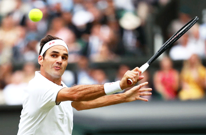 Switzerland's Roger Federer plays a backhand return against Italy's Matteo Berrettini