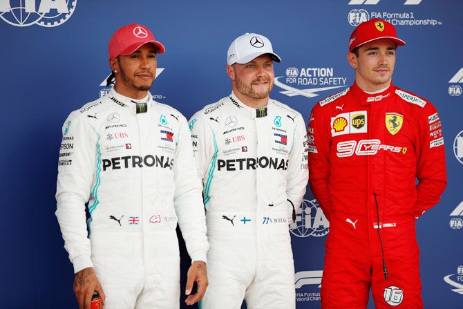 Mercedes' Lewis Hamilton who qualified in second position, Mercedes' Valtteri Bottas who qualified in pole position and Ferrari's Charles Leclerc who qualified in third position pose for a photo on the podium after qualifications for the British Grand Prix at the Silverstone Circuit, Silverstone, Britain on Saturday