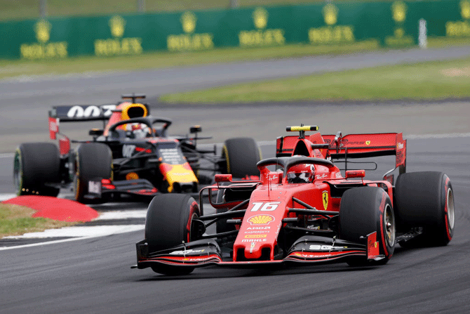 Monaco's Charles Leclerc driving the (16) Scuderia Ferrari SF90 leads Dutchman Max Verstappen driving the (33) Aston Martin Red Bull Racing RB15 on track during Silverstone Grand Prix