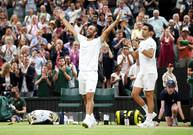 Colombia's Sebastian Cabal and doubles partner Juan Robert Farah rejoice after victory over Frenchmen Nicolas Mahut and Edouard Roger-Vasselin in their men's doubles final