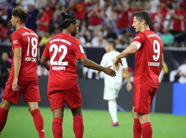 Bayern Munich's Sergio Gnabry and Robert Lewandowski celebrate a goal against Real Madrid on Saturday