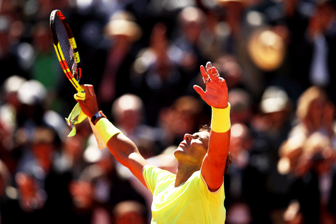 Spain's Rafael Nadal celebrates after defeating Switzerland's Roger Federer in their men's singles semi-final match at Roland Garros in Paris on Friday