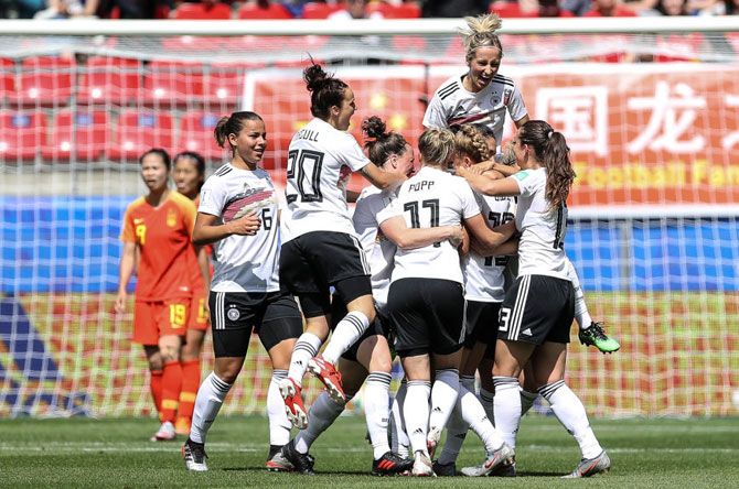 Giulia Gwinn celebrates with teammates after scoring her team's first goal in their group B match against China PR during the 2019 FIFA Women's World Cup at Roazhon Park in Rennes, France on Saturday