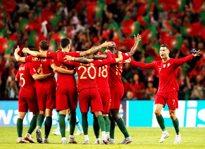 Portugal players celebrate winning the match at full time