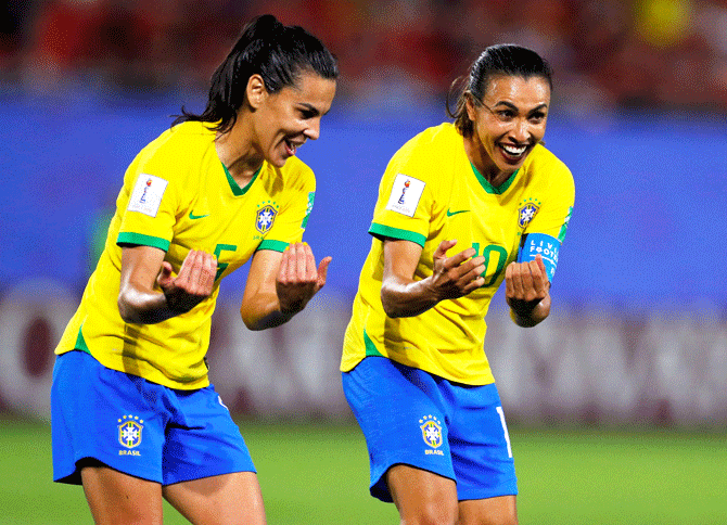 Brazil's Marta celebrates with her teammate Thaisa after scoring their first goal against Italy at Stade du Hainaut in Valenciennes, France, on Tuesday