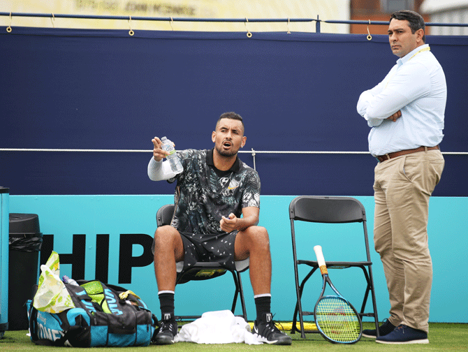 Australia's Nick Kyrgios speaks with a match official during his first round Singles Match against Spain's Roberto Carballes Baena during the Fever-Tree Championships at Queens Club in London, United Kingdom, on Thursday