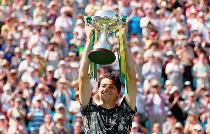 USA's Taylor Fritz celebrates with the trophy after defeating compatriot Sam Querrey to win the Eastbourne International Tennis tournament at Devonshire Park in Eastbourne, Britain on Saturday