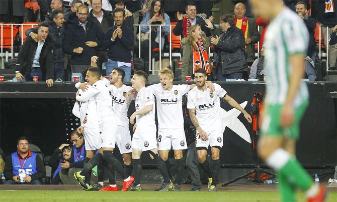 Valencia players celebrate after scoring against Real Betis at Mestalla stadium on Thursday