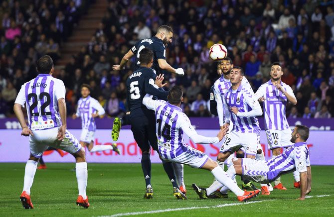 Real Madrid's Karim Benzema (centre) heads in to score his team's third goal against Real Valladolid CF during their La Liga match at Jose Zorrilla in Valladolid, Spain, on Sunday