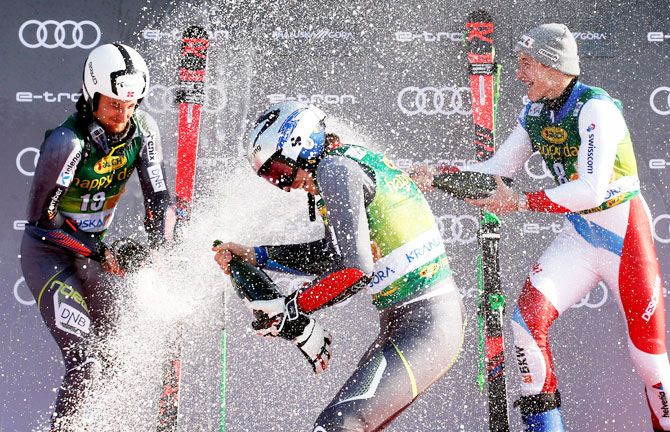 Norway's Henrik Kristoffersen celebrates winning the Men's Giant Slalom event with second placed Norway's Rasmus Windingstad and third placed Switzerland's Marco Odermatt at the Alpine Skiing World Cup on Saturday, March 9