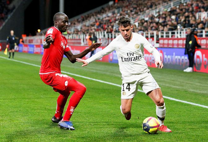 Paris St Germain's Juan Bernat in action with Dijon's Cedric Yambere during their Ligue 1 match at Stade Gaston Gerard, Dijon, France, on Tuesday