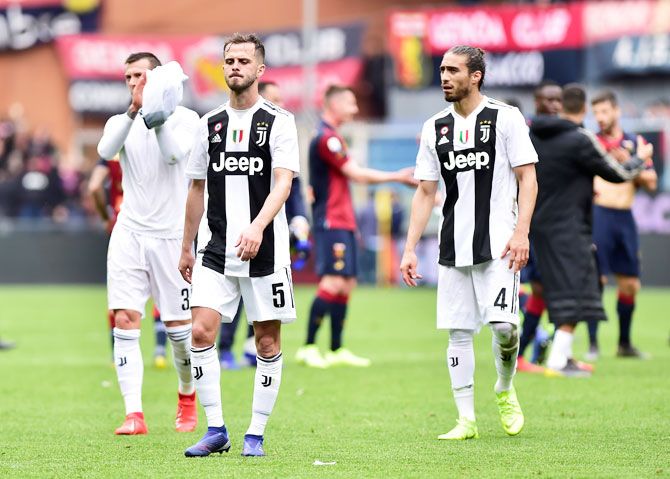 Juventus' Miralem Pjanic and Martin Caceres after their match against Genoa at Stadio Comunale Luigi Ferraris in Genoa on Sunday