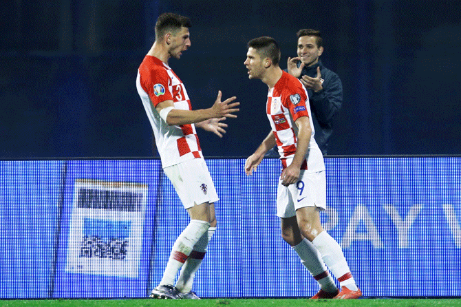 Croatia's Andrej Kramaric celebrates with Borna Barisic after scoring their second goal against Azerbaijan in their Euro 2020 Qualifier Group E match at Stadion Maksimir in Zagreb