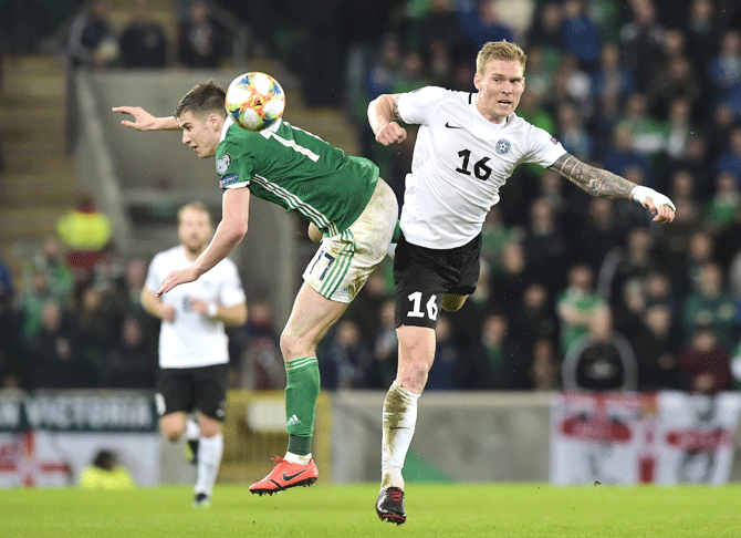 Estonia's Joonas Tamm and Northern Ireland's Paddy McNair vie for possession during their 2020 UEFA European Championships group C qualifier at Windsor Park in Belfast